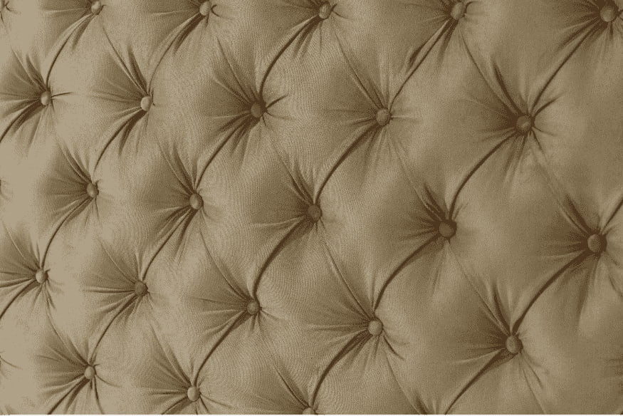Detalhe de tecido estofado com capitonê para cabeceira de cama.