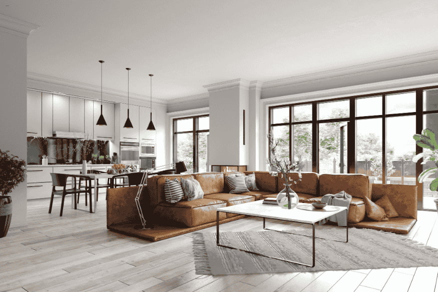 Sala integrada com cozinha e sofá de couro marrom, destacando decoração moderna para espaço pequeno.