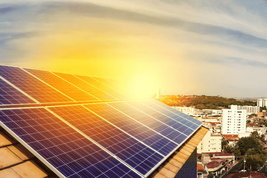 Painéis solares em telhado residencial recebendo luz do sol com vista da cidade.